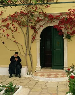 Monastery Collection: Resident monk at chapel door, Paleokastritsa Monastery, Corfu, Ionian Islands