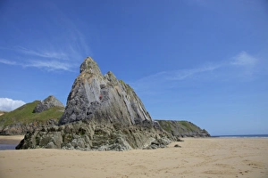 Two rock climbers on the Three Cliffs beach in spring morning sunshine Two rock climbers on the Three Cliffs beach in spring morning sunshine