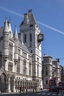 Street Collection: The Royal Courts of Justice, Central Civil Court, and red London bus on Fleet Street