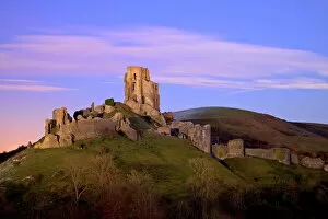 Castle Collection: The ruins of the 11th century Corfe Castle after sunset, near Wareham, Isle of Purbeck
