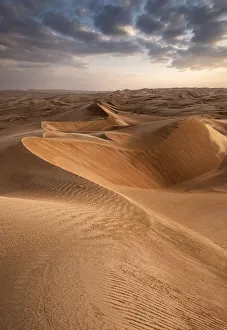 Sand dunes at sunset in the Wahiba Sands desert with clouds in the sky, Oman, Middle East Sand dunes at sunset in the Wahiba Sands desert with clouds in the sky, Oman, Middle East