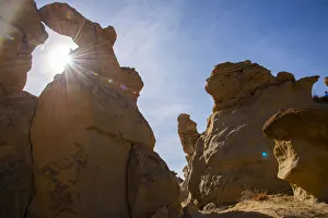 Sandstone sculptures and sun flare in Bisti/De-Na-Zin Wilderness in New Mexico Sandstone sculptures and sun flare in Bisti/De-Na-Zin Wilderness in New Mexico