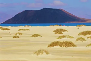 Sandy dunes and Isla de los Lobos in the background Sandy dunes and Isla de los Lobos in the background