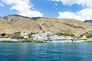 Seaside town resort of Hora Sfakion view from boat trip in the blue sea, Crete island, Greek Islands, Greece, Europe Seaside town resort of Hora Sfakion view from boat trip in the blue sea, Crete island, Greek Islands, Greece, Europe