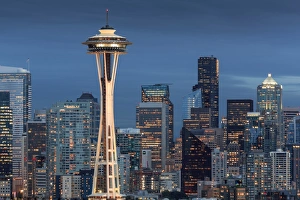 Seattle city skyline at night with illuminated office buildings and Space Needle Seattle city skyline at night with illuminated office buildings and Space Needle