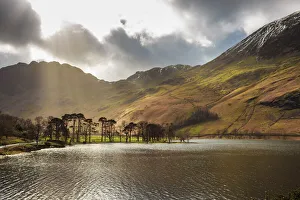 Shafts of light break through clouds to illuminate the fells in winter, Buttermere Shafts of light break through clouds to illuminate the fells in winter, Buttermere