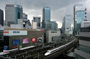 Trains Collection: Shinkansen bullet train weaving through maze of buildings in the Yurakucho district of downtown