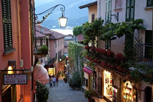 Usk Collection: Shopping street at dusk, Bellagio, Lake Como, Lombardy, Italy, Europe