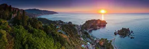 The Sicilian coast at sunrise, showing Isola Bella Beach, Taormina, Sicily, Italy The Sicilian coast at sunrise, showing Isola Bella Beach, Taormina, Sicily, Italy