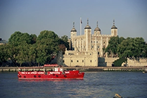 Sightseeing boat on the River Thames, and the Tower of London, UNESCO World Heritage Site Sightseeing boat on the River Thames, and the Tower of London, UNESCO World Heritage Site