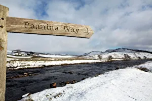 Sign for the Pennine Way walking trail on snowy landscape by the River Tees Sign for the Pennine Way walking trail on snowy landscape by the River Tees