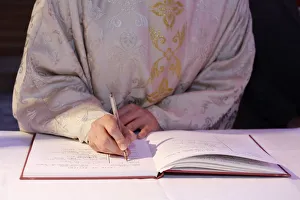 Signing the Baptism register, Mass of the sacraments at St Signing the Baptism register, Mass of the sacraments at St