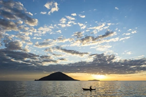 Silhouette of a man in a little fishing boat at sunset, Cape Malcear, Lake Malawi Silhouette of a man in a little fishing boat at sunset, Cape Malcear, Lake Malawi