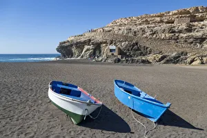 Small fishing boats on Playa Ajuy on the volcanic island of Fuerteventura, Canary Islands Small fishing boats on Playa Ajuy on the volcanic island of Fuerteventura, Canary Islands