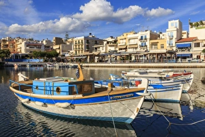 Small fishing boats reflected in Voulismeni Lake, Agios Nikolaos, Lasithi, Crete Small fishing boats reflected in Voulismeni Lake, Agios Nikolaos, Lasithi, Crete