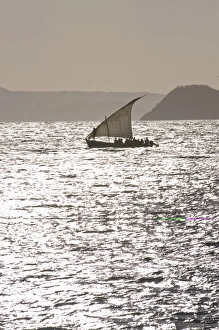 Small sailing boat at sunset near Diego Suarez (Antsiranana), Madagascar Small sailing boat at sunset near Diego Suarez (Antsiranana), Madagascar