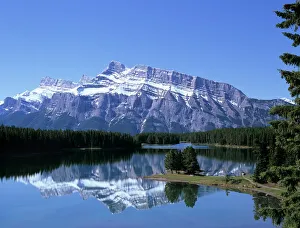 Snowy peak of Mount Rundle reflected in the water of Two Jack Lake, Banff National Park Snowy peak of Mount Rundle reflected in the water of Two Jack Lake, Banff National Park