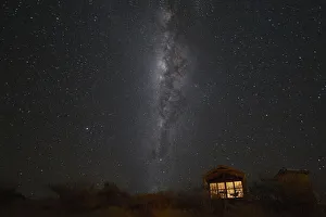 South hemisphere Milky Way and a small illuminated hut, Namibia, Africa South hemisphere Milky Way and a small illuminated hut, Namibia, Africa