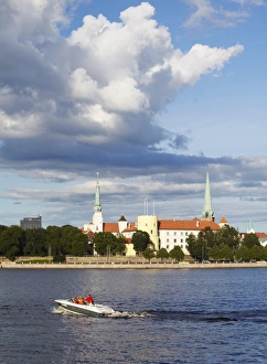 Speedboat on Daugava River with Riga Castle in background, Riga, Latvia Speedboat on Daugava River with Riga Castle in background, Riga, Latvia
