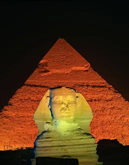 Egyptian Archaeological Sites Prints: The Sphinx and one of the pyramids illuminated at night, Giza, UNESCO World Heritage Site