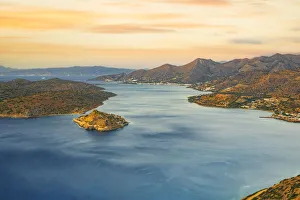Spinalonga island in the blue sea of Mirabello gulf at sunrise, Plaka, Lasithi prefecture Spinalonga island in the blue sea of Mirabello gulf at sunrise, Plaka, Lasithi prefecture