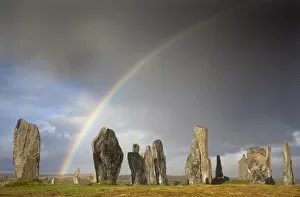 Images Dated 10th September 2012: Standing Stones of Callanish bathed in sunlight with a rainbow arching across the sky in
