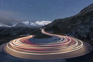 Star trail and lights of car traces, Bernina Pass, Poschiavo Valley, Engadine, Canton of Graubunden Star trail and lights of car traces, Bernina Pass, Poschiavo Valley, Engadine, Canton of Graubunden