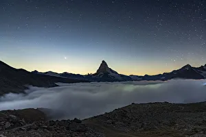 Starry night over Matterhorn in the mist, Zermatt, Valais Canton, Swiss Alps, Switzerland Starry night over Matterhorn in the mist, Zermatt, Valais Canton, Swiss Alps, Switzerland