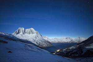 Stars of the polar night on the Senjahopen peak and frozen sea, Senja, Mefjordbotn Stars of the polar night on the Senjahopen peak and frozen sea, Senja, Mefjordbotn