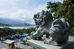 Stone lion overseeing the Danshui river from the Guandu Temple, Guandu, Taipei, Taiwan, Asia