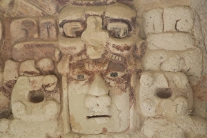 Stone mask of Mayan Sun God Kinichna, taken through protective glass, Becan, Mayan Ruins Stone mask of Mayan Sun God Kinichna, taken through protective glass, Becan, Mayan Ruins
