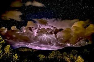 A storm approaching Sullivan Butte in Chino Valley at night with a starry sky above A storm approaching Sullivan Butte in Chino Valley at night with a starry sky above
