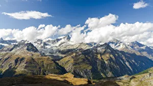 Sun shining over the Zinalrothorn mountain peak through clouds, Valais Canton, Swiss Alps Sun shining over the Zinalrothorn mountain peak through clouds, Valais Canton, Swiss Alps