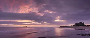 Sunrise over Bamburgh Castle and the Farne Islands, Northumberland, England Sunrise over Bamburgh Castle and the Farne Islands, Northumberland, England