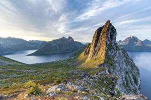 Sunrise over the clear water of the fjord and Segla mountain, Senja island, Troms county Sunrise over the clear water of the fjord and Segla mountain, Senja island, Troms county