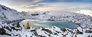 Sunrise over the snowcapped Orobie Alps and frozen lake Rogneda during a cold autumn Sunrise over the snowcapped Orobie Alps and frozen lake Rogneda during a cold autumn