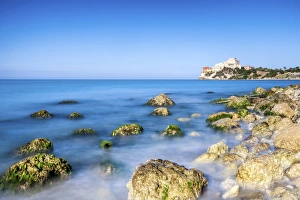 Sunrise on turquoise sea frames the medieval Falconara Castle, Butera, Province of Caltanissetta Sunrise on turquoise sea frames the medieval Falconara Castle, Butera, Province of Caltanissetta
