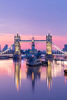 Sunrise view of HMS Belfast and Tower Bridge reflected in River Thames Sunrise view of HMS Belfast and Tower Bridge reflected in River Thames