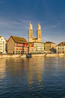 Sunset over Grossmunster Cathedral and Limmatquai street along the banks of Limmat River Sunset over Grossmunster Cathedral and Limmatquai street along the banks of Limmat River