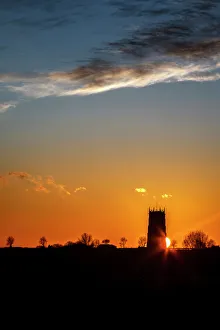 Sunset behind the Parish Church of the Holy Trinity and All Saints at Winterton on Sea Sunset behind the Parish Church of the Holy Trinity and All Saints at Winterton on Sea
