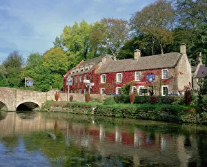 The Swan Hotel reflected in the river at Bibury in the Cotswolds, Gloucestershire The Swan Hotel reflected in the river at Bibury in the Cotswolds, Gloucestershire