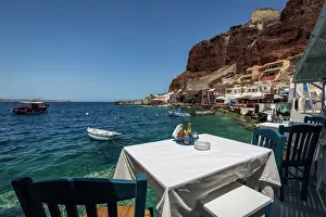 A table with a view at one of the seafood restaurants in Ammoudi Bay (Amoudi) at A table with a view at one of the seafood restaurants in Ammoudi Bay (Amoudi) at