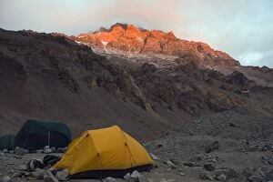 Tents at Plaza de Mulas base camp, with sunset on Aconcagua 6962m, highest peak in South America