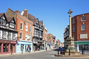 Tewkesbury Town centre shops and the Tewkesbury War Memorial (The Cross), Tewkesbury, Gloucestershire, England Tewkesbury Town centre shops and the Tewkesbury War Memorial (The Cross), Tewkesbury, Gloucestershire, England