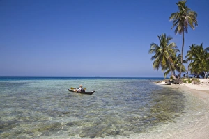 Tourist in sea cayak, Silk Caye, Belize, Central America Tourist in sea cayak, Silk Caye, Belize, Central America
