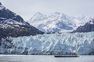 A tourist ship explores the Lamplugh Glacier in Glacier Bay National Park and Preserve A tourist ship explores the Lamplugh Glacier in Glacier Bay National Park and Preserve