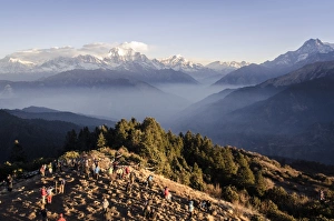 Tourists gather on Poon Hill to watch the sunrise over the Annapurna Himal, with Dhaulagiri, 8167m, Dhampus Peak, 6012m, and Tukuche Peak, 6920m and Nilgiri, 7061m, visible in the background, Annapurna Conservation Area, Nepal, Himalayas, Asia Tourists gather on Poon Hill to watch the sunrise over the Annapurna Himal, with Dhaulagiri, 8167m, Dhampus Peak, 6012m, and Tukuche Peak, 6920m and Nilgiri, 7061m, visible in the background, Annapurna Conservation Area, Nepal, Himalayas, Asia
