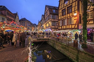 Tourists shopping at the Christmas Markets in the old medieval town of Colmar, Haut-Rhin department Tourists shopping at the Christmas Markets in the old medieval town of Colmar, Haut-Rhin department