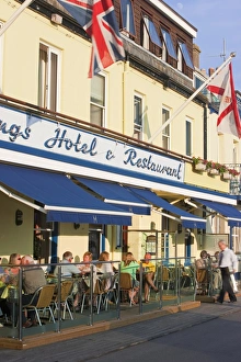 Tourists sitting outside restaurants and bars, Gorey harbour, Jersey, Channel Islands Tourists sitting outside restaurants and bars, Gorey harbour, Jersey, Channel Islands