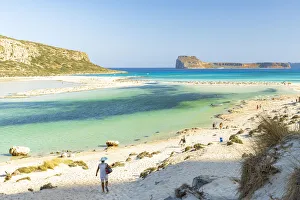 Tourists walking to the white sand beach surrounding Balos lagoon, Crete, Greek Islands Tourists walking to the white sand beach surrounding Balos lagoon, Crete, Greek Islands